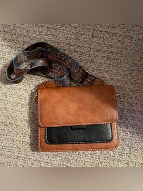 Brown Crossbody Bag with Black Front Pocket and Patterned Strap
